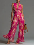 Tuta Fucsia Smanicata in Chiffon con Stampa Floreale, Pantaloni Plissettati a Gamba Larga e Chiusura con Cerniera