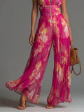 Tuta Fucsia Smanicata in Chiffon con Stampa Floreale, Pantaloni Plissettati a Gamba Larga e Chiusura con Cerniera
